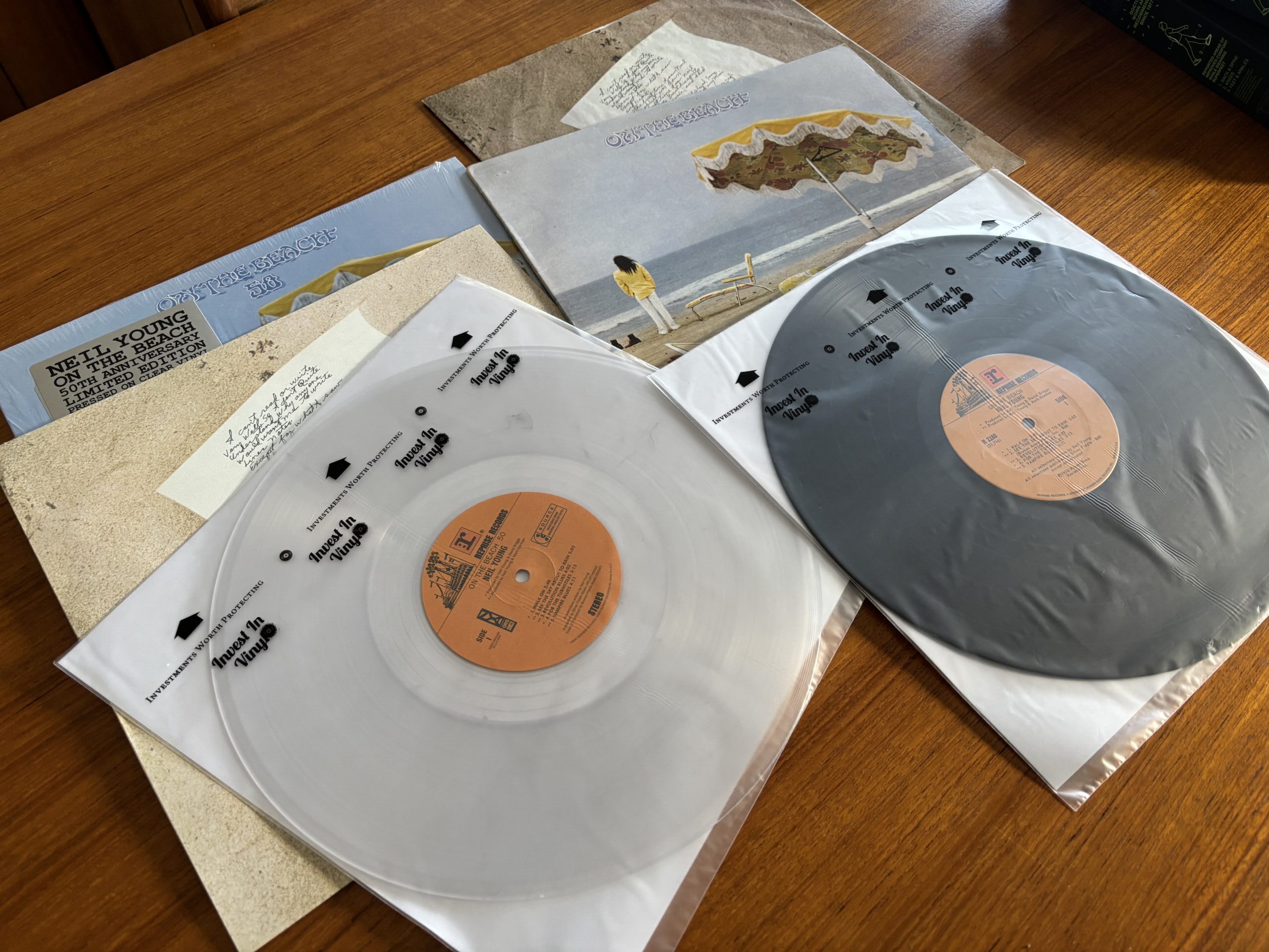 Original and reissue vinyl pressings of Neil Young On the Beach displayed side by side