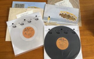 Comparison of Neil Young original vinyl and 50th anniversary clear vinyl pressing, showing vintage and modern records side by side.