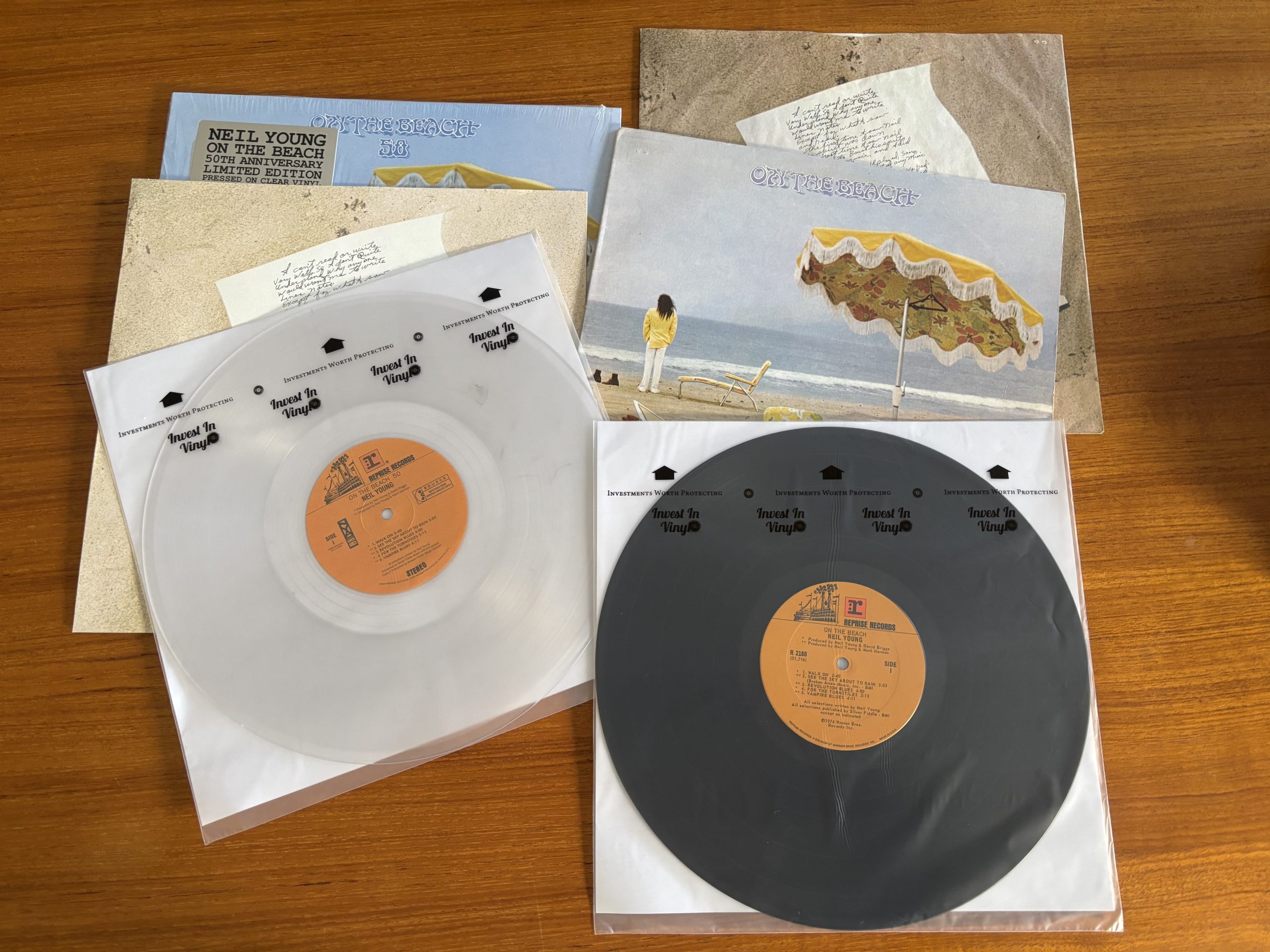 Comparison of Neil Young original vinyl and 50th anniversary clear vinyl pressing, showing vintage and modern records side by side.