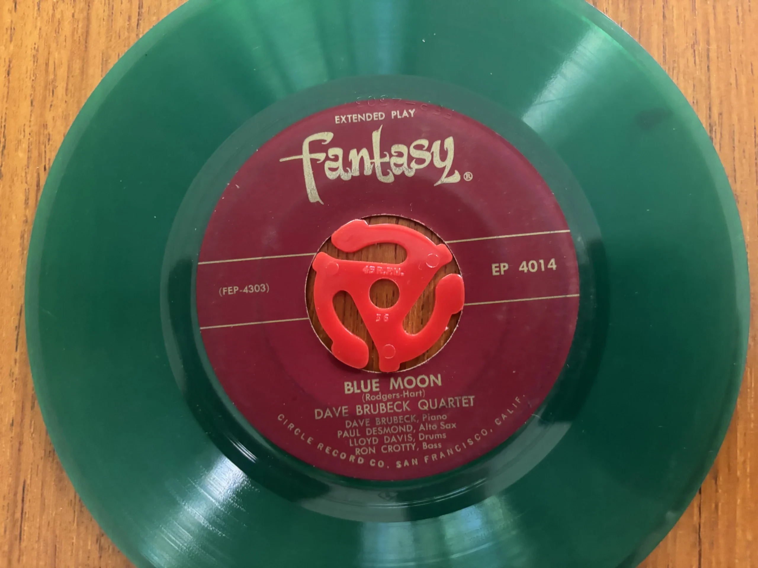 45 RPM record with a red adapter inserted in the center holeyl Record Collecting
