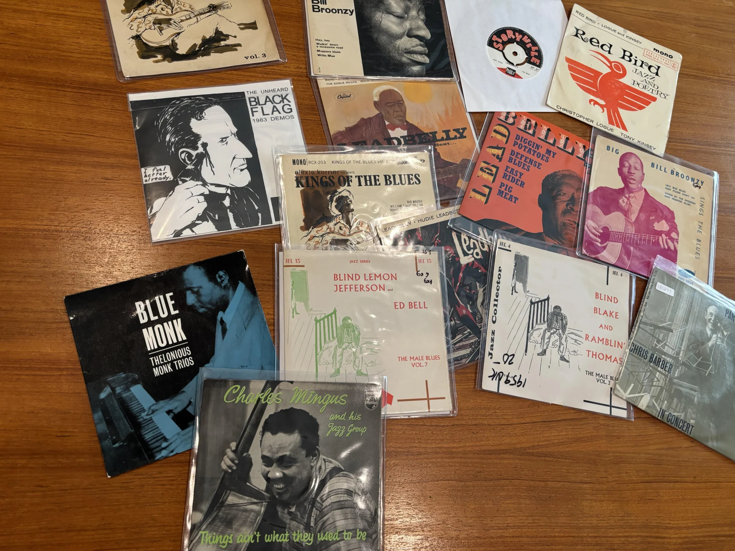 Stack of vintage 45 RPM vinyl records with large center holes and colorful record labels