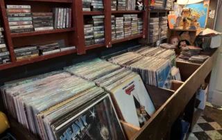 Rows of used vinyl record bins at Scavenged Goods vintage store in Denver, Colorado.