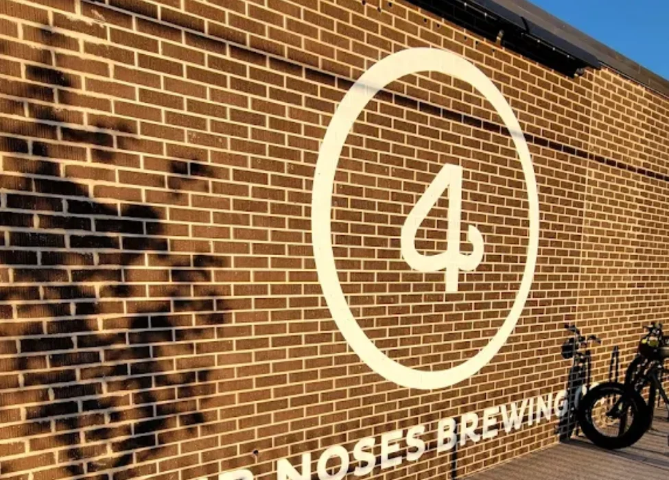 Guests enjoying vinyl records and craft beer during Vinyl Listening Night at Four Noses Brewing.