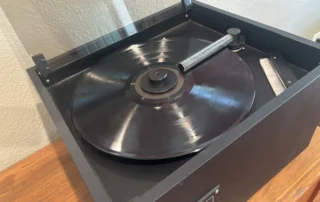 Vinyl record being cleaned on a VPI record cleaning machine to help reduce dust, debris, and static buildup