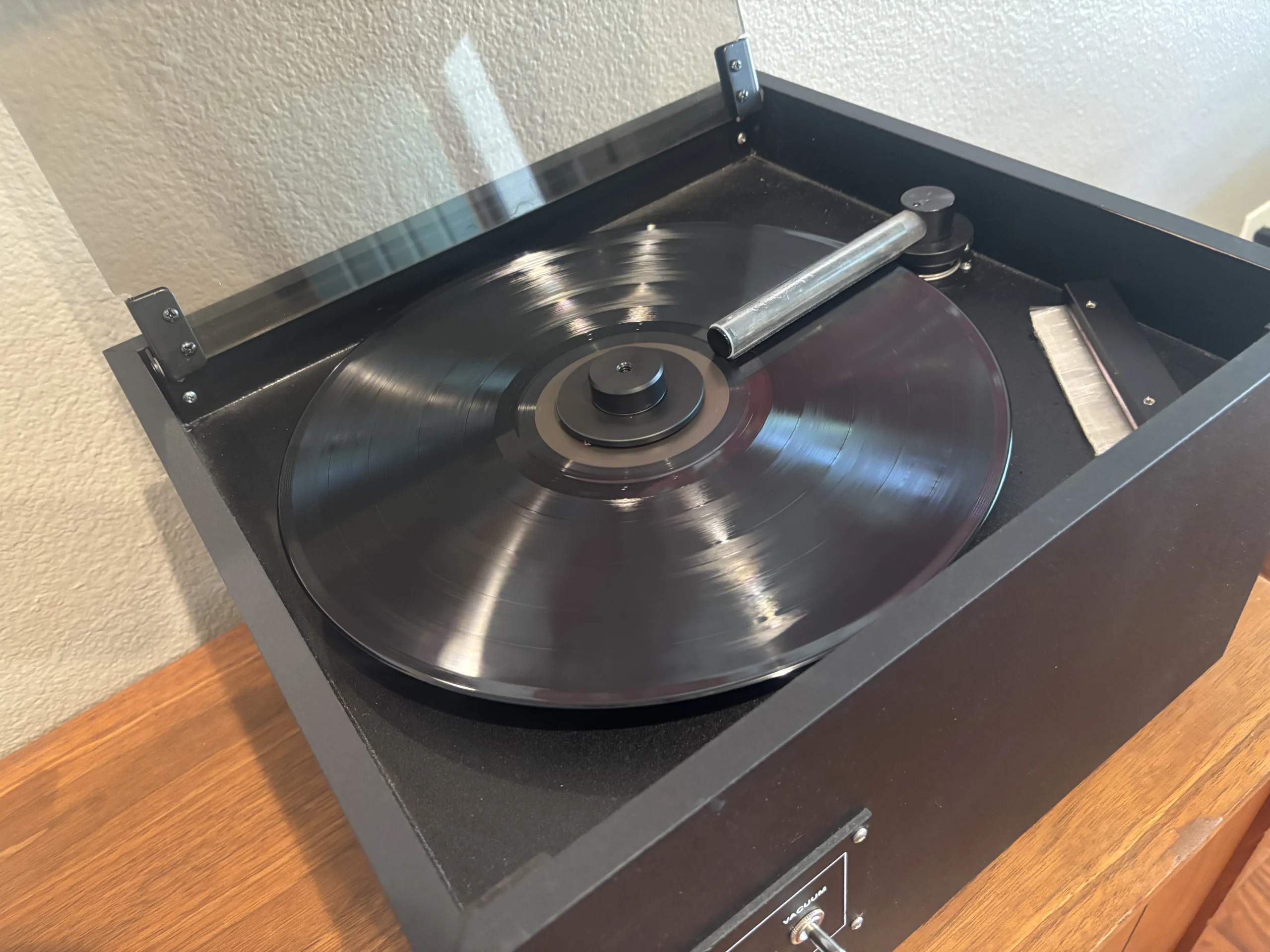 Vinyl record being cleaned on a VPI record cleaning machine to help reduce dust, debris, and static buildup