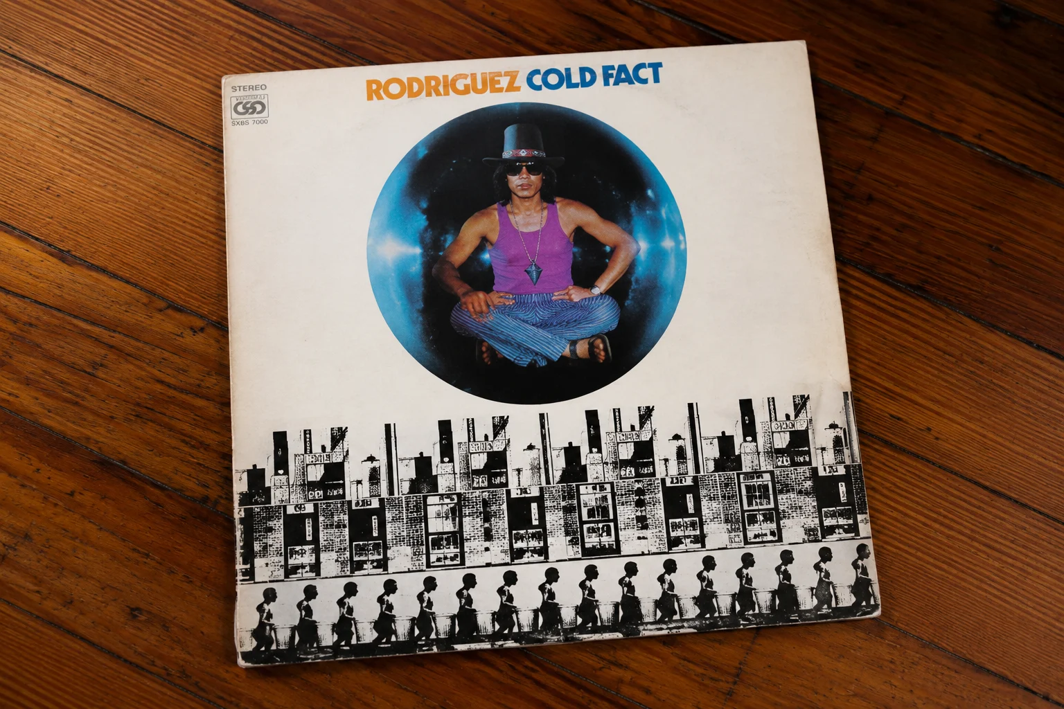 Sixto Rodriguez Cold Fact album cover on a teak table