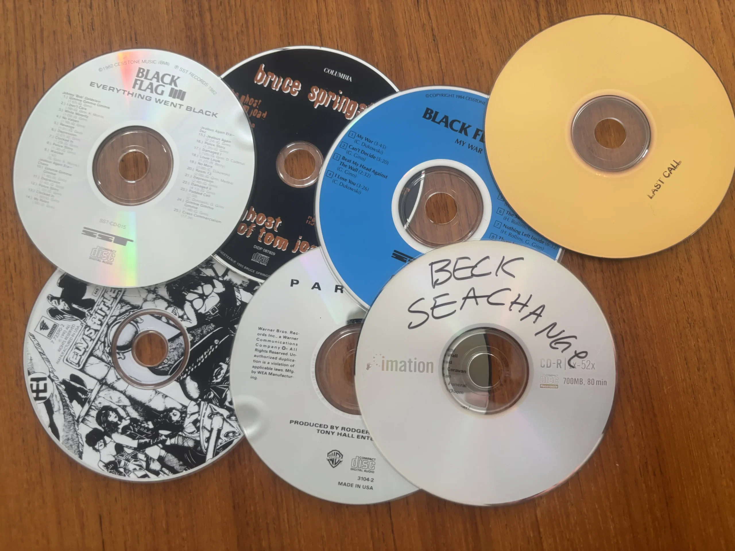 Factory-pressed audio CDs and recordable CD-R discs showing the difference between commercial CDs and burned media